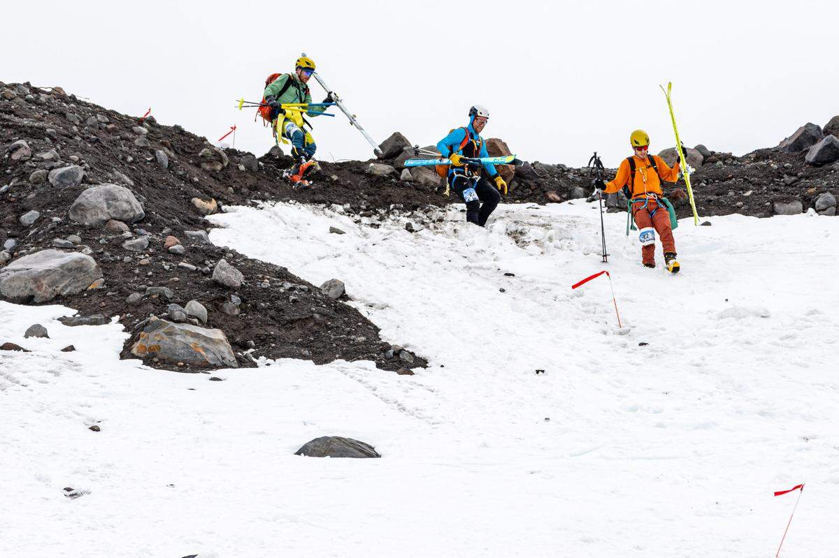 Andrew Wagner, Brad Lipovsky and Kyle Skelton traverse volcanic rock on the Kulshan Randonnée course on Mount Baker in 2024.