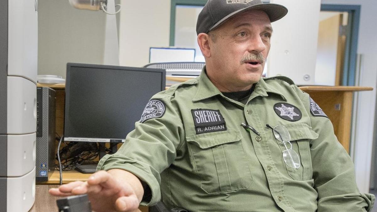 Whatcom County Sheriff’s Deputy Randy Adrian talks about ankle monitoring bracelets at the Whatcom County Jail Interim Work Center on Feb. 4, in Bellingham. A task force is looking at whether electronic home monitoring should be expanded in an effort to keep some people out of the overcrowded jail.