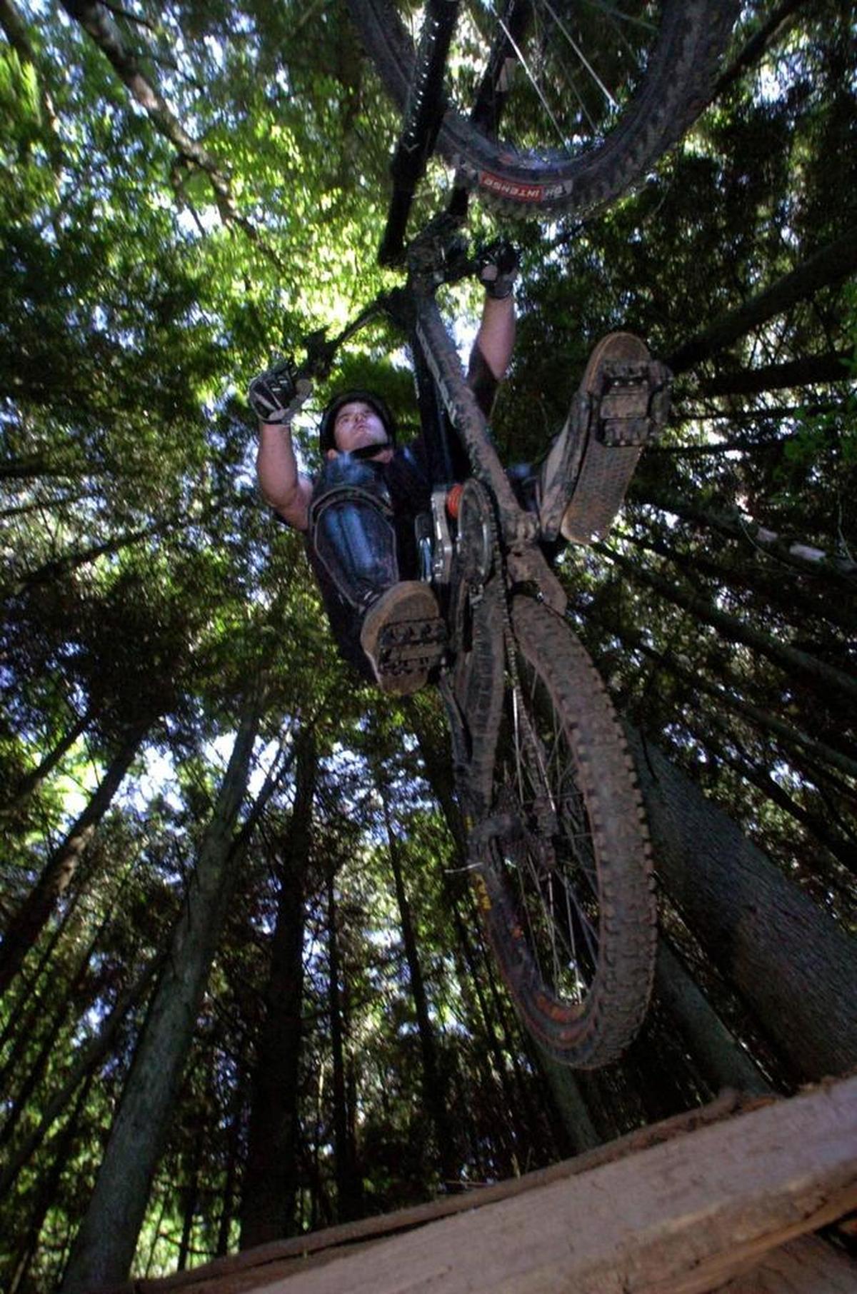 Bill Hawk flies over a jump he made with friends on the Evolution trail on Galbraith Mountain.