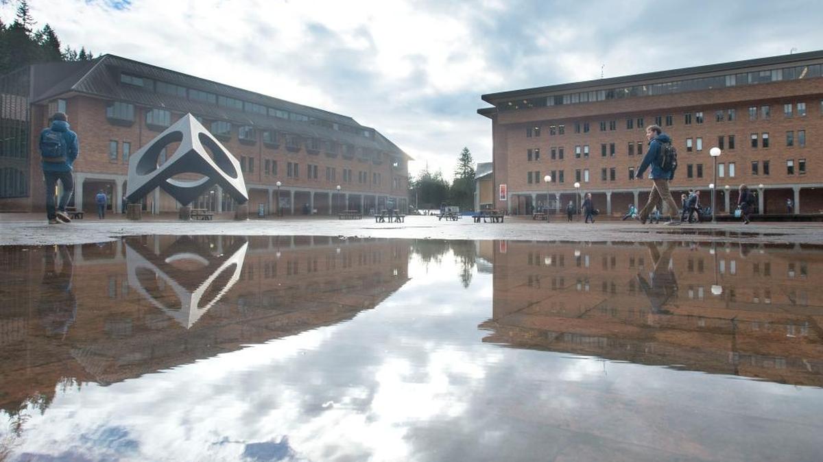 Students and staff avoid large puddles of water on Red Square during a break in the rainy weather at Western Washington University on Tuesday, Jan. 26, 2016. Heavier rain is expected Wednesday, but no flooding - other than puddles.