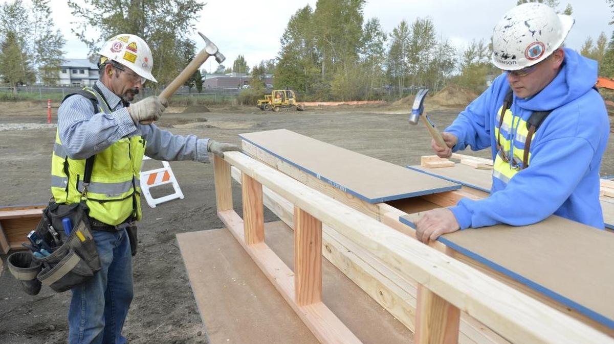 Dawson Construction workers Rick Strissel, left, and Corey Presler build cement forms for a retention pond at the Catholic Housing Services of Western Washington low income apartments being built on West Bakerview Road east of Northwest Drive in Bellingham, Wednesday, Oct. 21, 2015. While construction activity picked up in 2015, the local industry is still well below pre-recession levels.