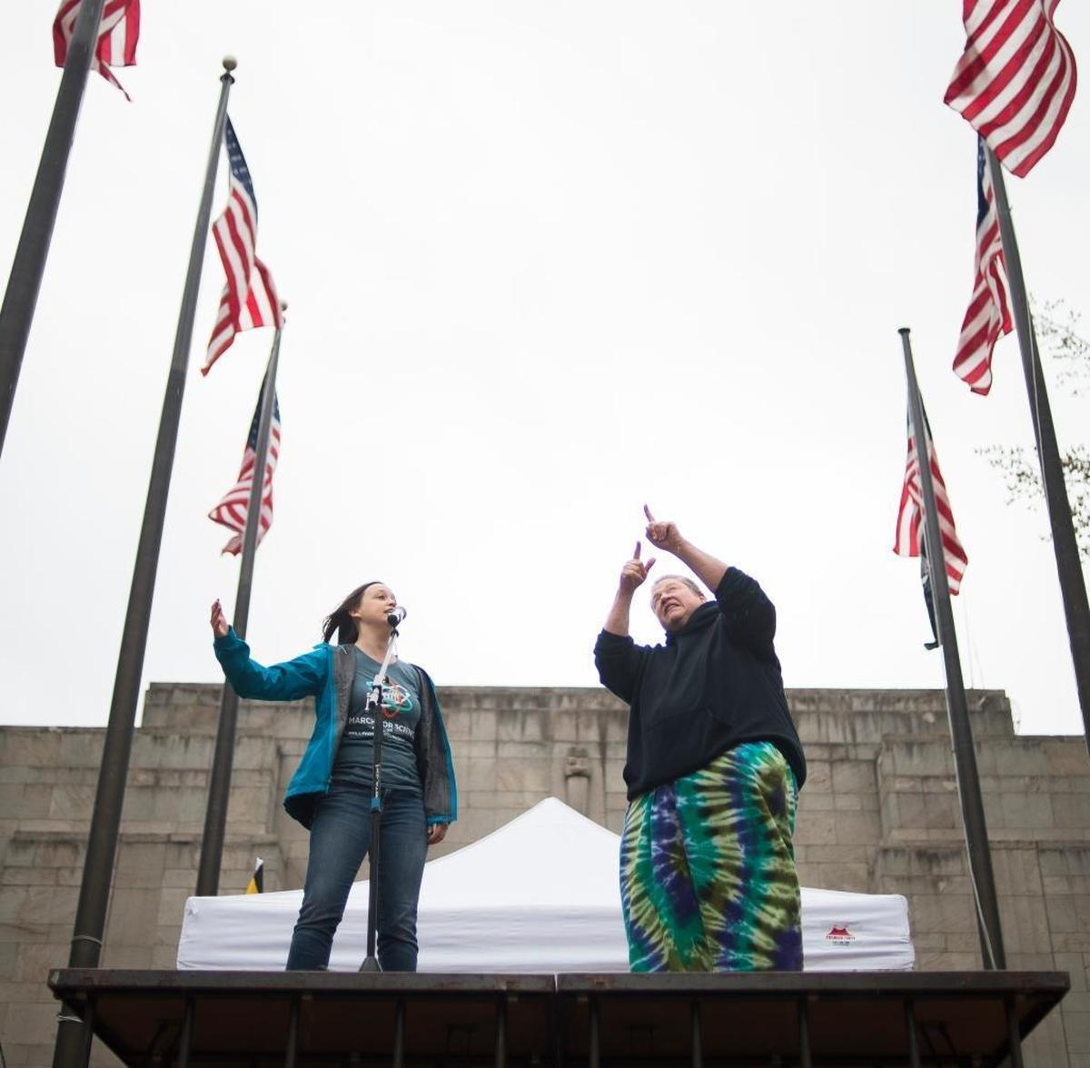 Melissa Rice, left, speaks to the crowd in front of Bellingham City Hall at the Bellingham March For Science on Saturday, April 22, in Bellingham.
