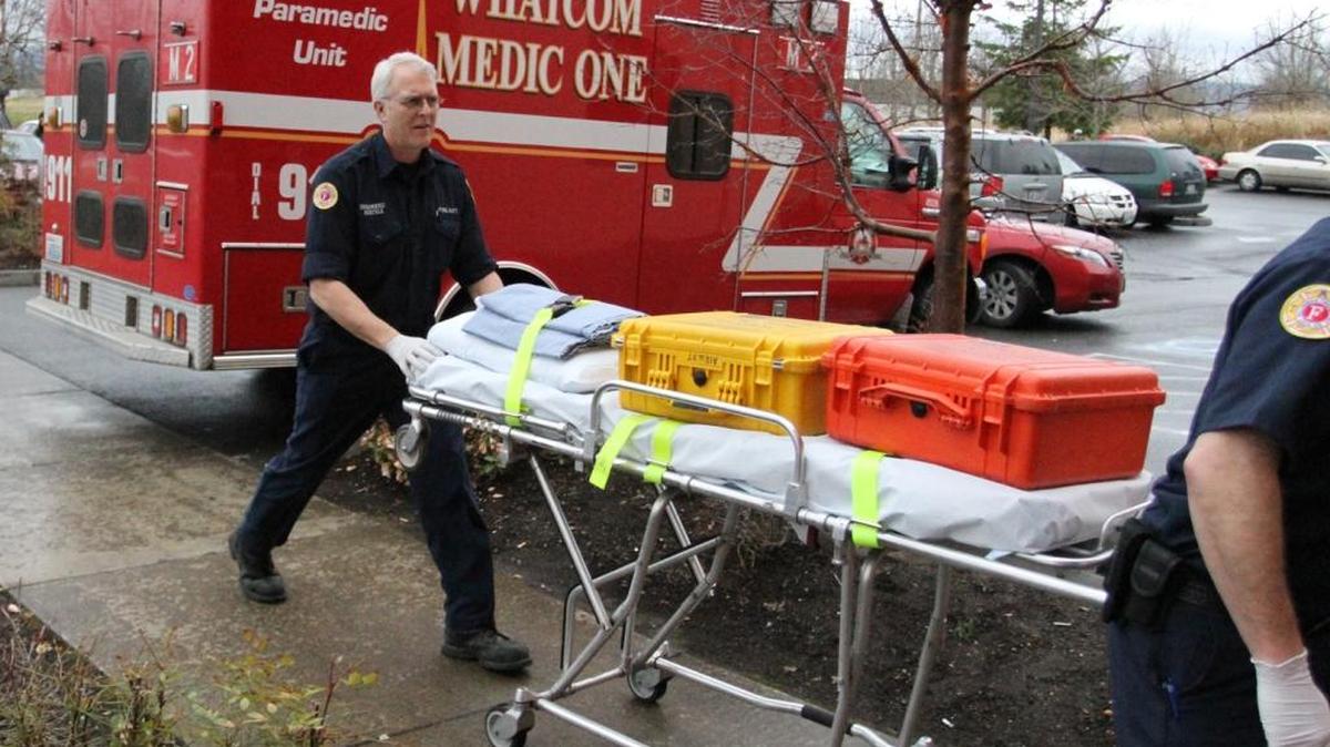 Joe Bertels, a paramedic with Whatcom Medic One, wheels a gurney into Sea Mar Community Health Center during a response on Friday afternoon, March 9, 2012 in Bellingham. Voters may be asked to approve a new property tax levy in November 2016 to fund medic services.