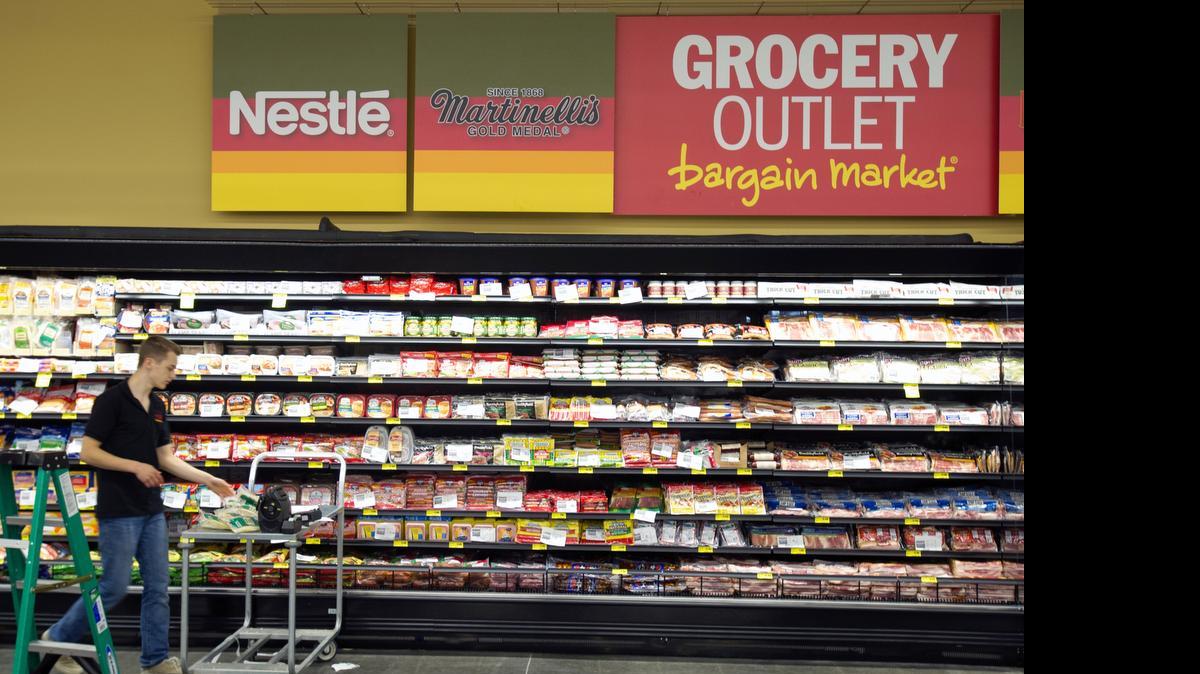 An employee stocks cheese at the Ferndale Grocery Outlet in 2015. A new store is opening in Lynden April 11.