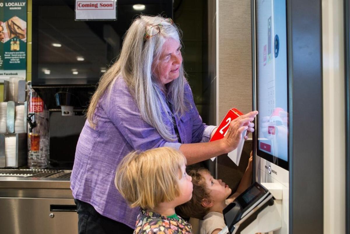 Bev Wiltshire and her grandchildren Cora Schrengohst, right, and Betty Schrengohst, left, try out a new ordering kiosk at McDonald's on Telegraph Road Thursday, June 1, in Bellingham.