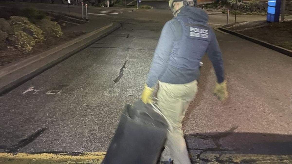 Bellingham Police Officer Alvarez secured an improvised explosive device outside of St. Joseph Medical Center on May 8, 2024, in Bellingham, Wash. The container is designed to protect a person from shrapnel or fumes that could discharge if the explosive is detonated.
