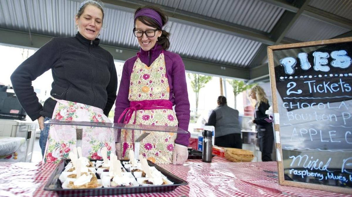 Alice Clark, left, and employee Baltina Hong prepare Alice’s Pies for the Bite of Bellingham on Sept. 22, 2013, at the Depot Market Square. Clark has been named the interim executive director for the Downtown Bellingham Partnership.