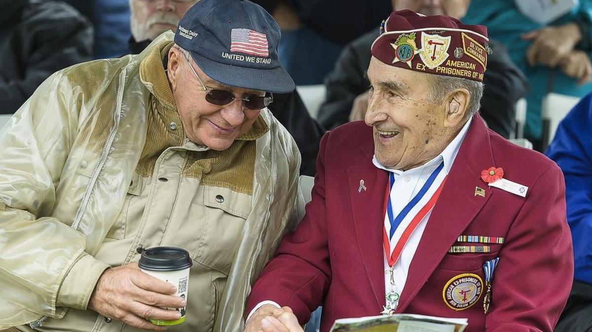World War II veterans Bob Van Weerdhuizen, left, and Joe Moser share memories before the start of the 50th annual Festival of Flags and Remembrance Ceremony at Greenacres Memorial Park in Ferndale, Wash., on Monday afternoon May 25, 2015.