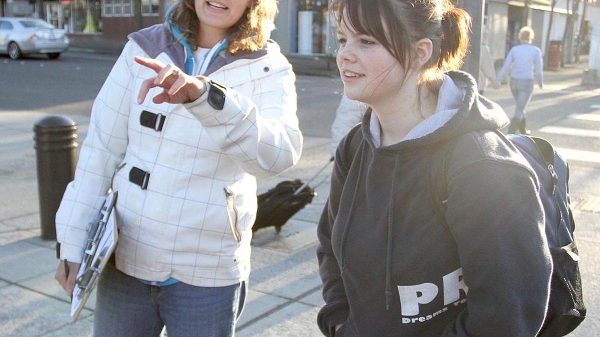Riannon Bardsley, executive director for Northwest Youth Services, points towards the bus station as she talks to Shia Teague, 15, during the annual Whatcom homeless count on Jan. 26, 2012.
