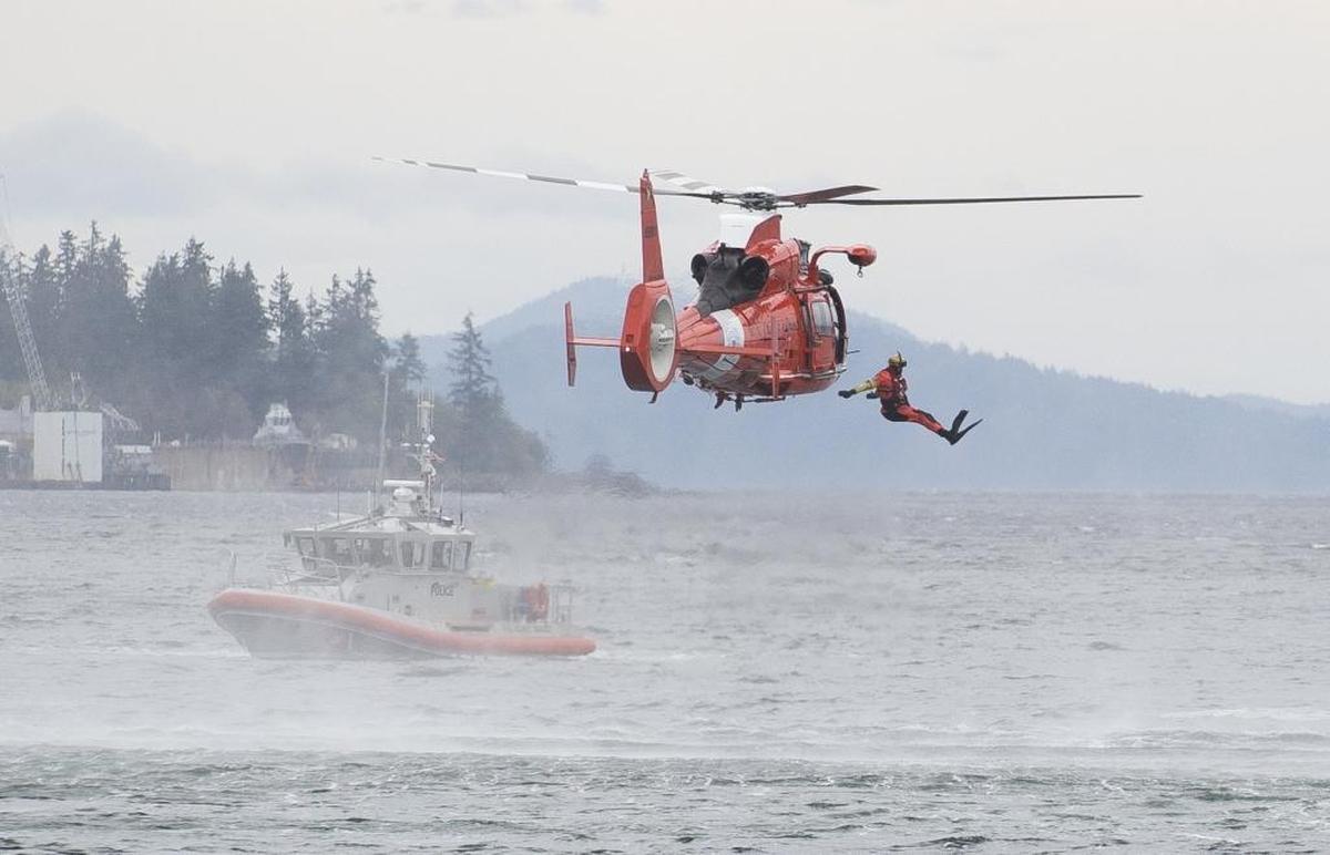 A Coast Guard rescue swimmer jumps from a helicopter during a demonstration of sea rescue techniques at the first Bellingham SeaFeast in 2016.