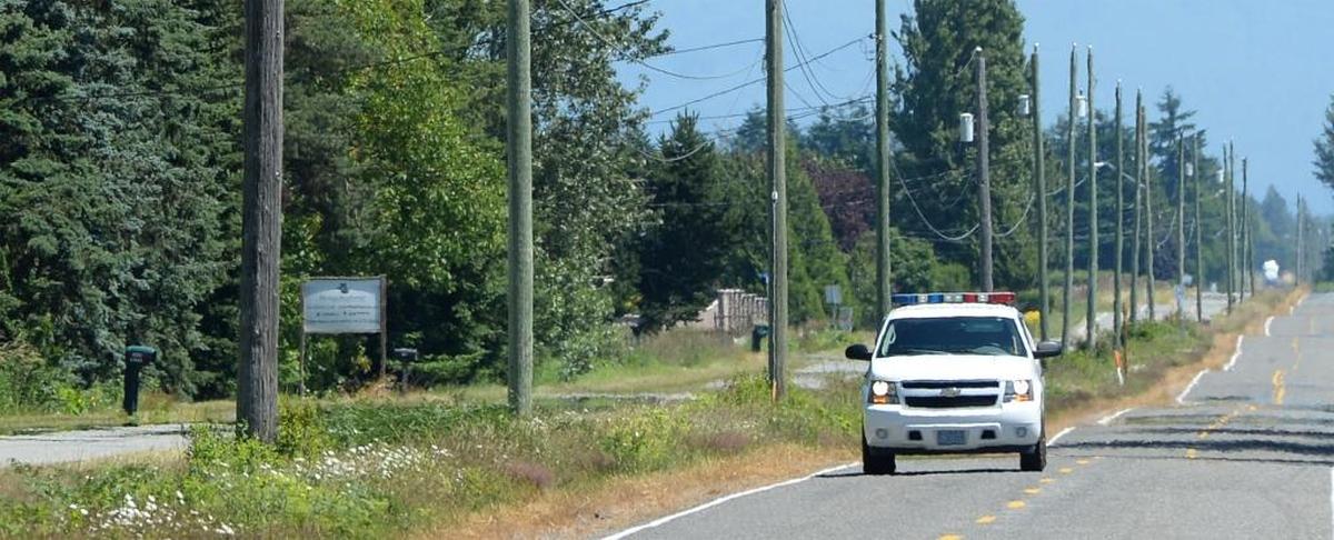 A U.S. Border Patrol vehicle patrols the U.S.-Canada border on East Boundary Road north of Lynden, Thursday, June 22, 2017. The two countries are separated only by a ditch between 0 Avenue in Canada, on the left, and Boundary Road in the U.S., at right.