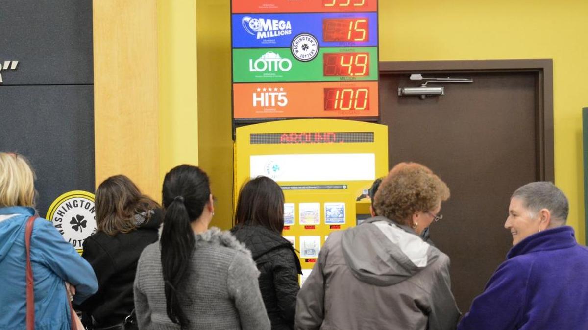 Customers line up to buy Powerball tickets at the Fred Meyer store on West Bakerview Road in Bellingham on Tuesday, Jan 12, 2016. With the Powerball jackpot up to an estimated $1.5 billion, the store had to rope off a line for the crowd at the lottery kiosk.