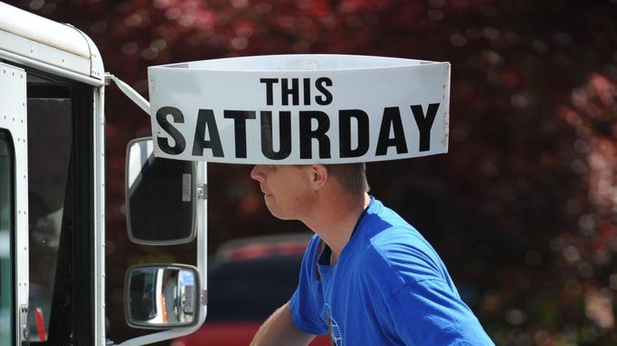 Mail carrier Mark Rensink wears his food drive hat while delivering the mail to businesses along Squalicum Parkway May 9, 2014, in Bellingham to remind his customers about the annual Letter Carrier Food Drive Saturday. The 2016 drive is May 14.