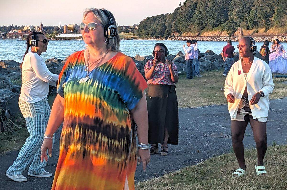 People participate in a a Silent Disco during sunset at Boulevard Park in Bellingham on July 20, 2024. Photo by
