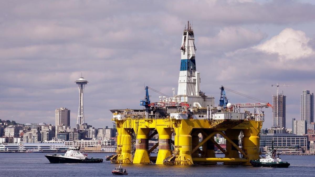 FILE - In this May 14, 2015, file photo, the oil drilling rig Polar Pioneer is towed toward a dock in Elliott Bay in Seattle. The rig is the first of two drilling rigs Royal Dutch Shell is outfitting for Arctic oil exploration. Some environmental groups say the Obama administration’s approval of the final permit to drill for oil in the Arctic Ocean clashes with the message he will deliver when he visits Alaska later this month. Obama plans to emphasize the dangers of climate change. (AP Photo/Elaine Thompson, File)