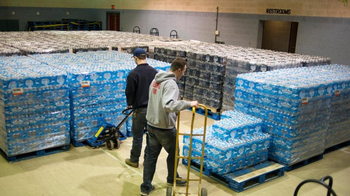Workers moving pallets holding bottled water at a distribution site in Sebring, Ohio, Feb. 2, 2016. Water contamination has turned up in scores of communities in recent years, like Sebring, and experts cite holes in the safety net of rules and procedures.