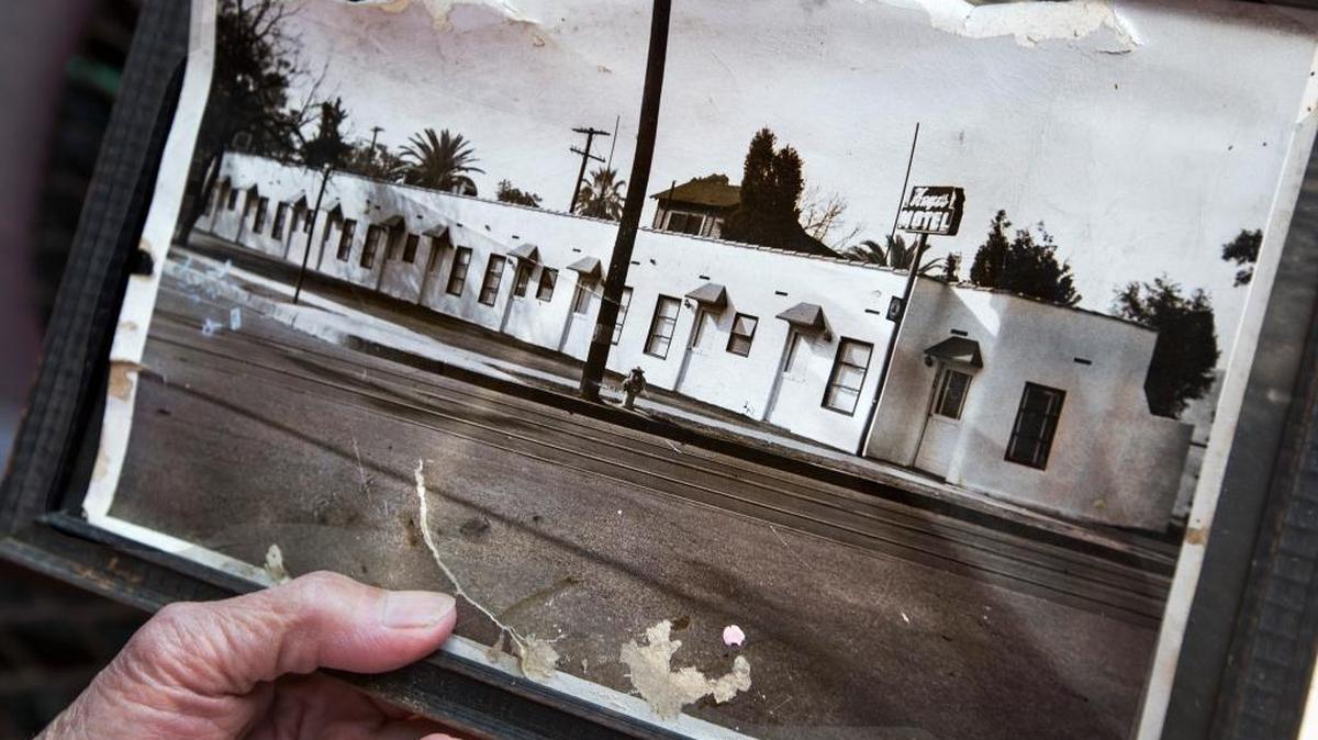 Lily Ho, 78, holds a vintage photo of the Hayes Motel on April 28, 2016 in Los Angeles. Her family has owned the motel for nearly 40 years and it was listed in the Green Book, a travel guide for African Americans.