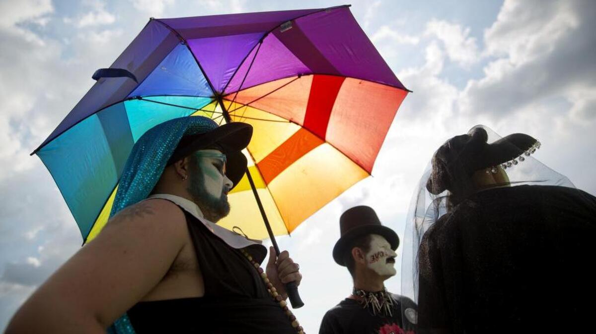 Ezekiel Davis, left, Charles Phillips and Chris Courtney stand outside the visitation for Pulse nightclub shooting victim Javier Jorge-Reyes in a show of solidarity Wednesday, June 15, in Orlando, Florida.
