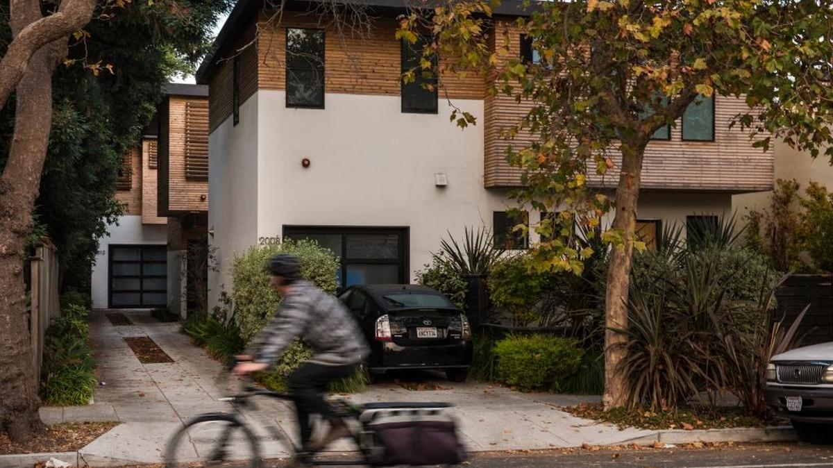 Three homes sit on a single plot of land in Berkeley, Calif., Oct. 11, 2017. As cities struggle to keep up with demand, they have remade their skylines with condominium and apartment – but single-family neighborhoods, where low-density living is treated as sacrosanct, have rarely been part of the equation.