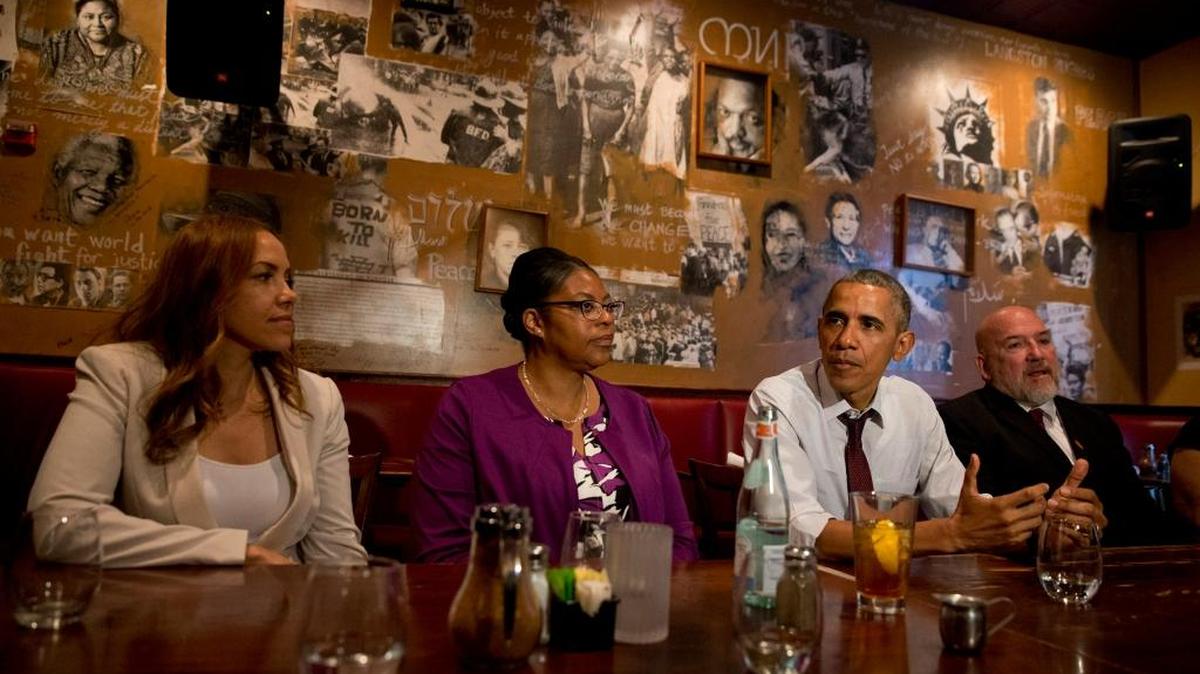 President Barack Obama meets with people who were formerly incarcerated and have previously received commutations, Wednesday, March 30, 2016, at Busboys and Poets restaurant in northwest Washington. From left are, Serena Nunn, Ramona Brant, the president and Phillip Emmert.