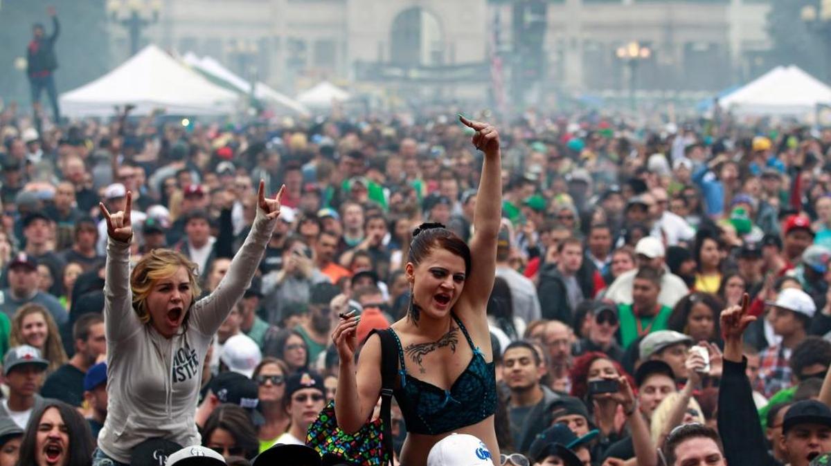 Members of a crowd numbering tens of thousands smoke marijuana and listen to live music, at the Denver 420 pro-marijuana rally at Civic Center Park in Denver in 2013. More than half of the population of the U.S. now has access to medical marijuana, which puts pressure on the federal government to update a decades-old marijuana policy that most experts agree is out of step with current scientific understanding of the drug and its risks and benefits.