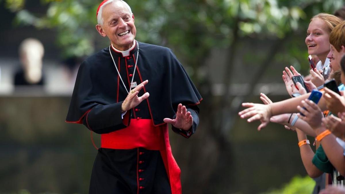 Cardinal Donald Wuerl, Archbishop of Washington, D.C., waves to school children after he and Pope Francis arrived at the Apostolic Nunciature, the Vatican’s diplomatic mission in the heart of Washington, D.C., after giving an address to a joint meeting of Congress in 2015.