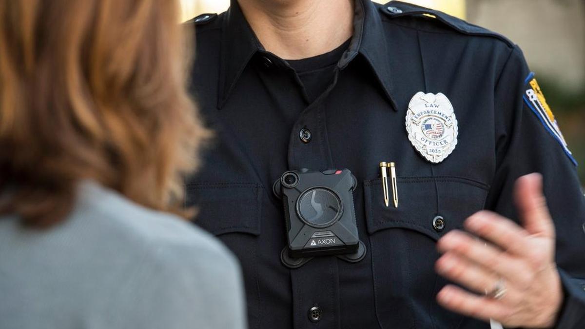 A law enforcement officer wears a body camera made by Axon. Confounding expectations, the largest study yet conducted found that police officers wearing body cameras used force and faced civilian complaints at about the same rates as officers without cameras.