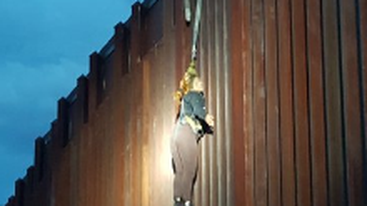 Smugglers lowering a woman over the border fence near Nogales, Ariz., fled when Border Patrol agents approached, leaving the woman dangling from the fence about 15 feet off the ground.