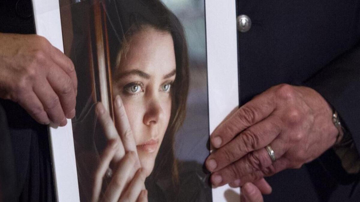 Deborah Ziegler holds a photo of her daughter, Brittany Maynard, with her husband, Gary Holmes .