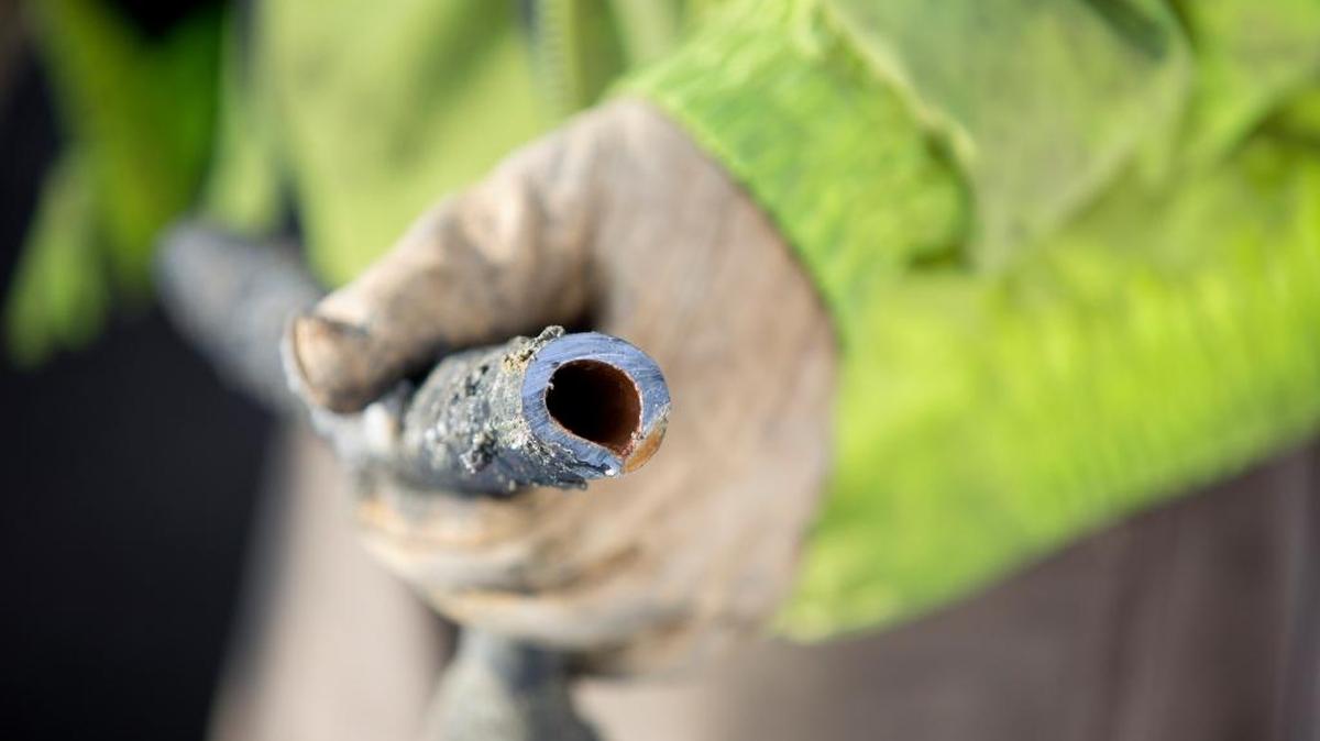 In this 2016 file photo a worker is holding the remains of a lead water pipe that was removed from a home in Lansing, Mich.. Missouri and Kansas have some of the nation’s highest numbers of lead pipes running from water mains into homes.