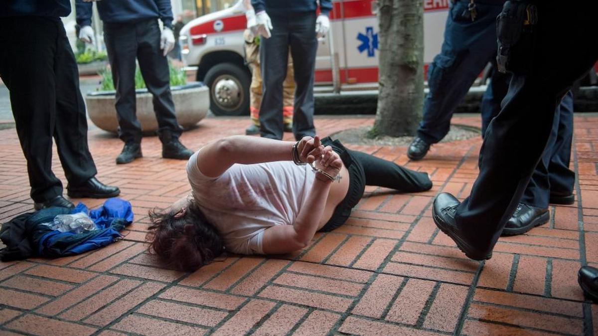 A woman who police and other first responders handcuffed in downtown Portland, Ore., March 14, 2016. In response to high-profile shootings of people with mental illness, police departments around the country are turning to crisis intervention training.