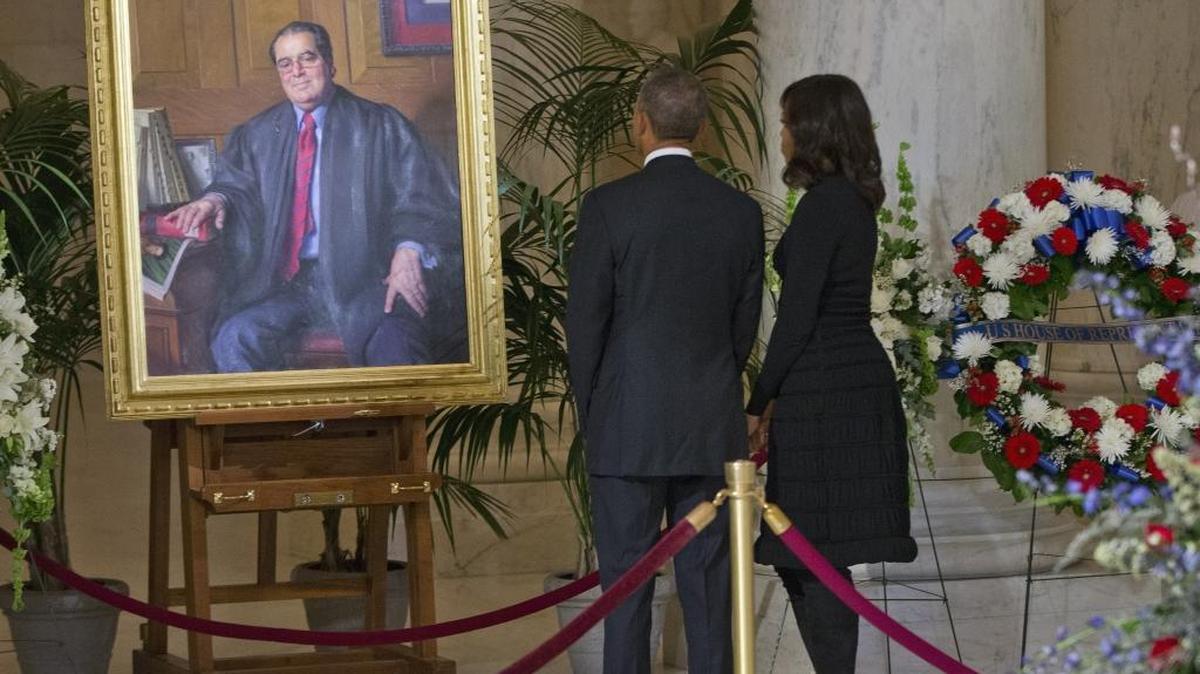 President Barack Obama and first lady Michelle Obama stop to look at a portrait of Supreme Court Justice Antonin Scalia after paying their respects at Scalia’s casket in the Great Hall of the Supreme Court in Washington, Friday, Feb. 19. Scalia spent nearly three decades as one of the high court’s most influential members.
