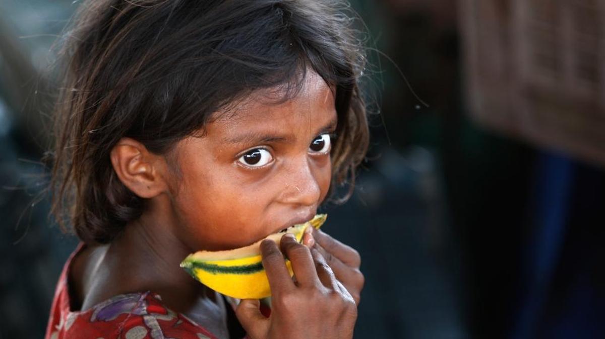 An Indian child laborer eats a piece of a muskmelon on the World Day against Child Labor on the outskirts of Jammu, India, June 12, 2015. Despite the country’s rapid economic growth, child labor remains widespread in India, where an estimated 13 million children work, with laws meant to keep kids in school and out of the workplace routinely flouted.