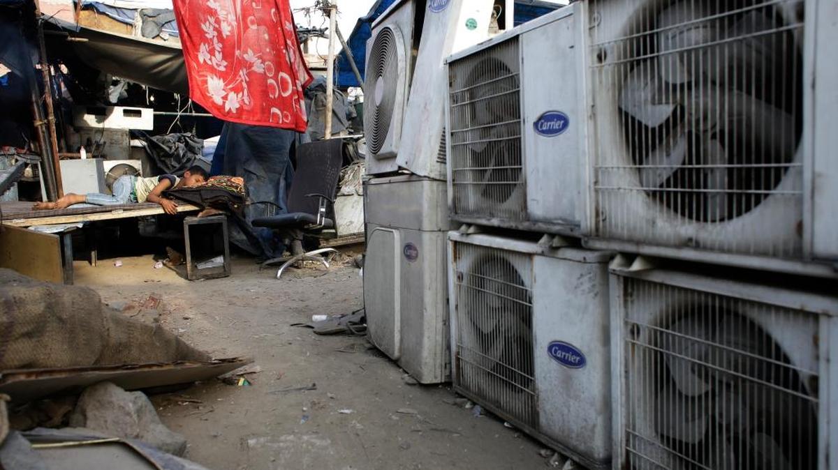 An Indian boy of a migrant daily wageworker sleeps near air conditioner shop at a market place in New Delhi, India, Tuesday, May 17, 2016. Scorching summer temperatures, hovering well over 40 degrees Celsius (104 degrees Fahrenheit), are making life extremely tough for millions of poor people across north India. Without access to air coolers or air conditioning and sometimes even an electric fan, they struggle to cope with the heat in their inadequate homes.