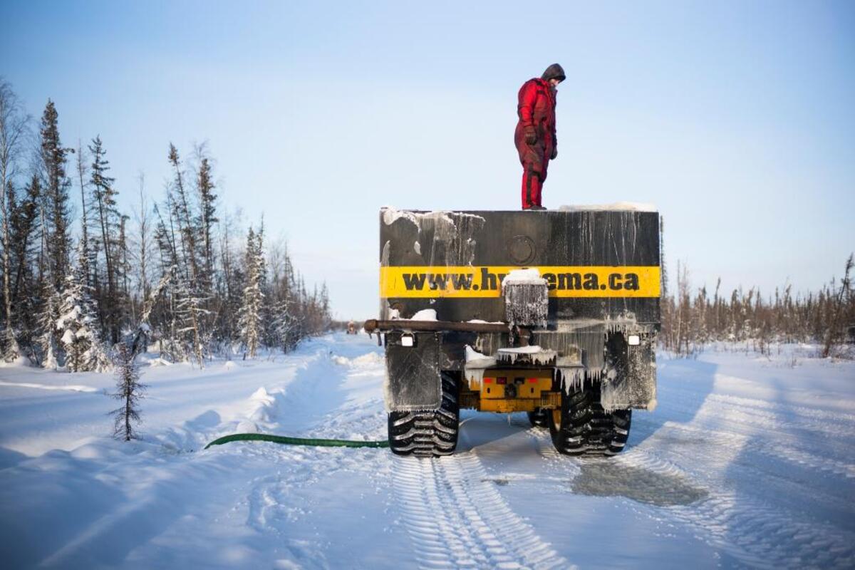 Dean Faure refills his water truck along the Tlicho winter road, north of Yellowknife, Northwest Territories, Canada, Jan. 21, 2017. Canada’s ice roads in the Northwest, where many communities are reachable only by barge and air most of the year, have been freezing later and melting earlier, drastically reducing the precious window of time isolated residents rely on to restock a year’s worth of vital supplies.