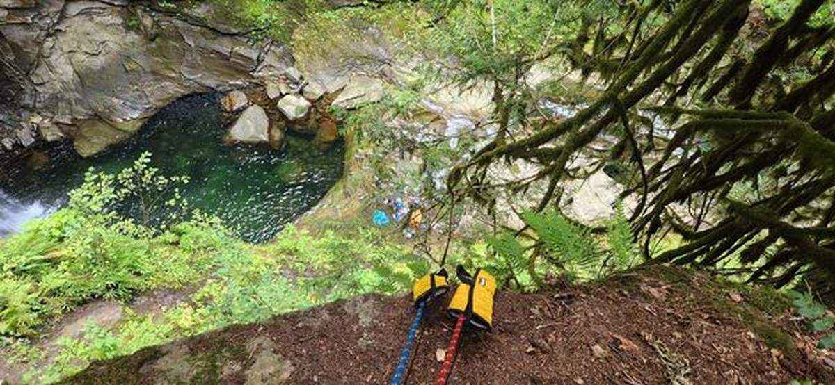Firefighters brought the woman up from the falls in a stretcher after rappelling down to her at Racehorse Falls in Whatcom County.