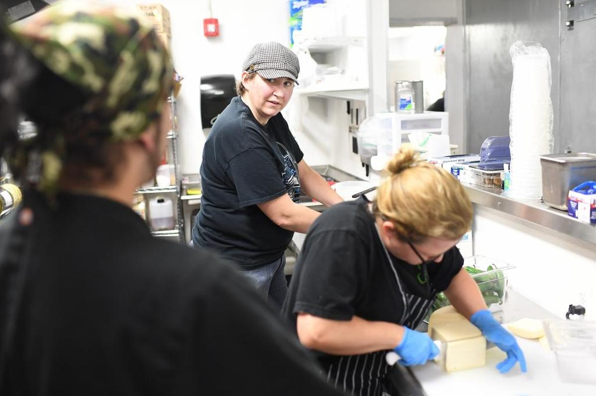 Chris Tryon, left, talks to Pizza Carrello co-owner Ariane Jimison while Janine Dunbar works at right in Gillette, Wyoming.