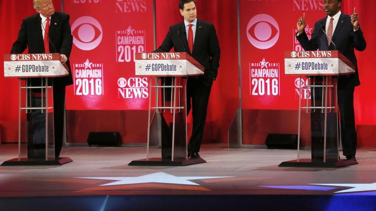 Republican presidential candidate, retired neurosurgeon Ben Carson, right, speaks as Republican presidential candidate, businessman Donald Trump and Republican presidential candidate, Sen. Marco Rubio, R-Fla., look on during the CBS News Republican presidential debate at the Peace Center, Feb. 13, 2016, in Greenville, S.C. Peace Corps volunteer worries presidential contenders’ campaign rhetoric is harming the goodwill mission.