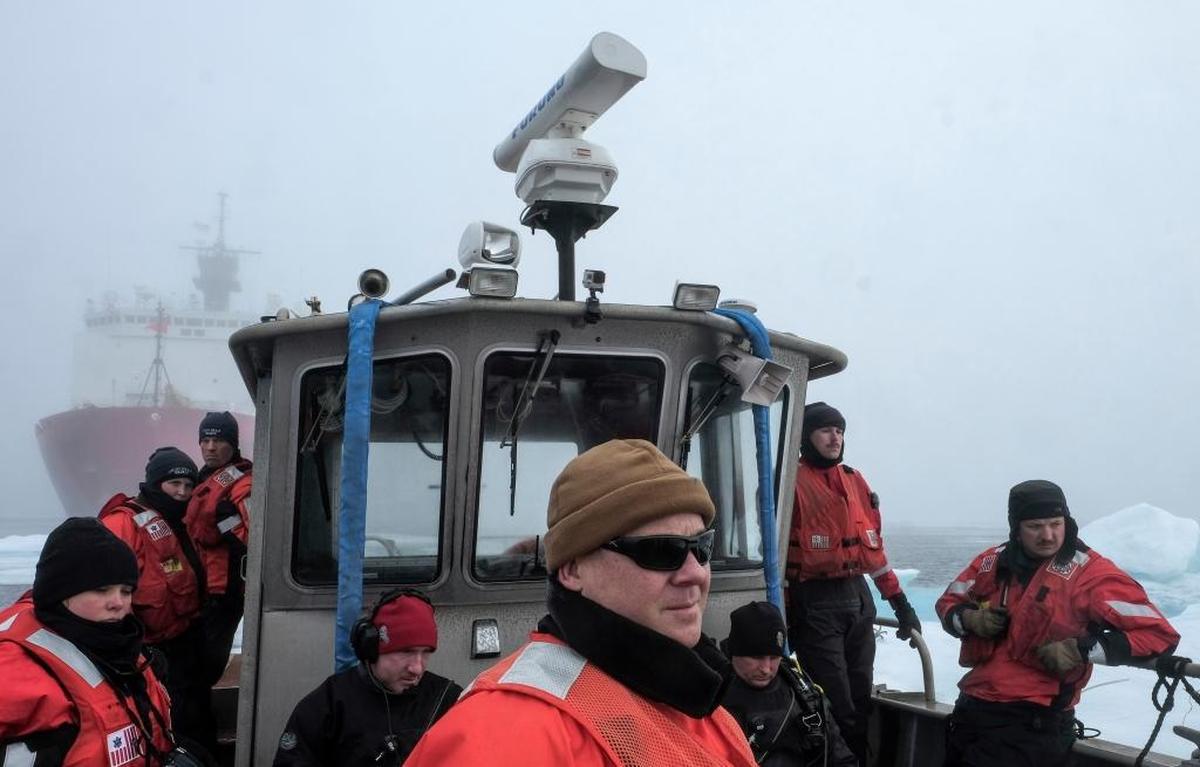 Navy Senior Chief Petty Officer Randle Groves, center, participates in a joint Coast Guard-Navy dive operation July 30 off the U.S. Coast Guard Cutter Healy.