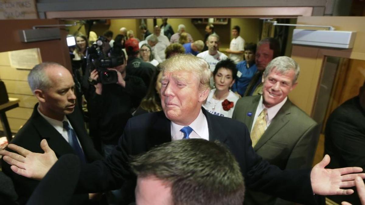 Republican presidential candidate Donald Trump reacts to supporters after meeting with volunteers at the local Pizza Ranch restaurant, Jan. 15, 2016, in Waukee, Iowa.