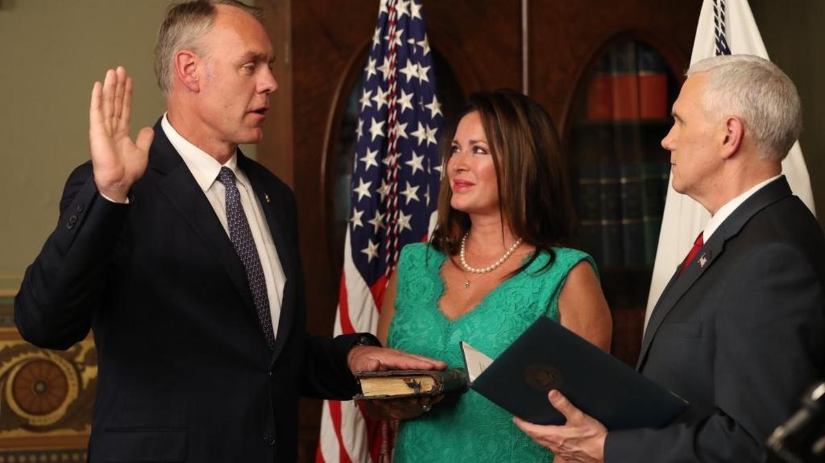 Vice President Mike Pence administers the oath of office to Interior Secretary Ryan Zinke, Wednesday, March 1, 2017, in the Eisenhower Executive Office Building on the White House complex in Washington, as his wife Lolita holds the Bible.