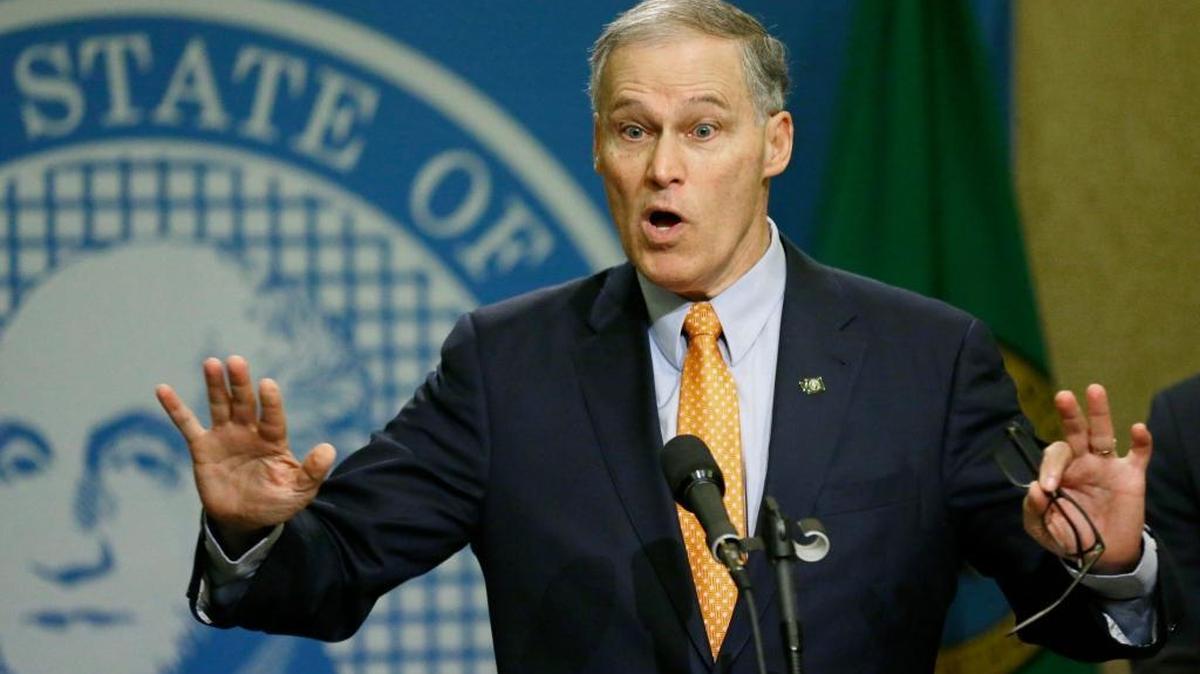 Washington Gov. Jay Inslee talks to reporters, Thursday, Feb. 23, 2017, at the Capitol in Olympia, Wash., after he signed an executive order to ensure that state workers don’t help carry out President Donald Trump’s immigration policies. Trump has said he wants to expand the number of deportations of people in the country illegally, and Inslee said Thursday that his order reaffirms the state’s commitment to tolerance and ensures that state workers roles are to provide services for residents and not to enforce immigration statutes.