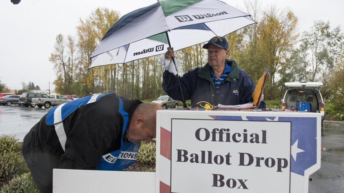 Bob Grasher, left, and Bob Parrish collect ballots from the drop box in the Ferndale City Hall parking lot in 2016.