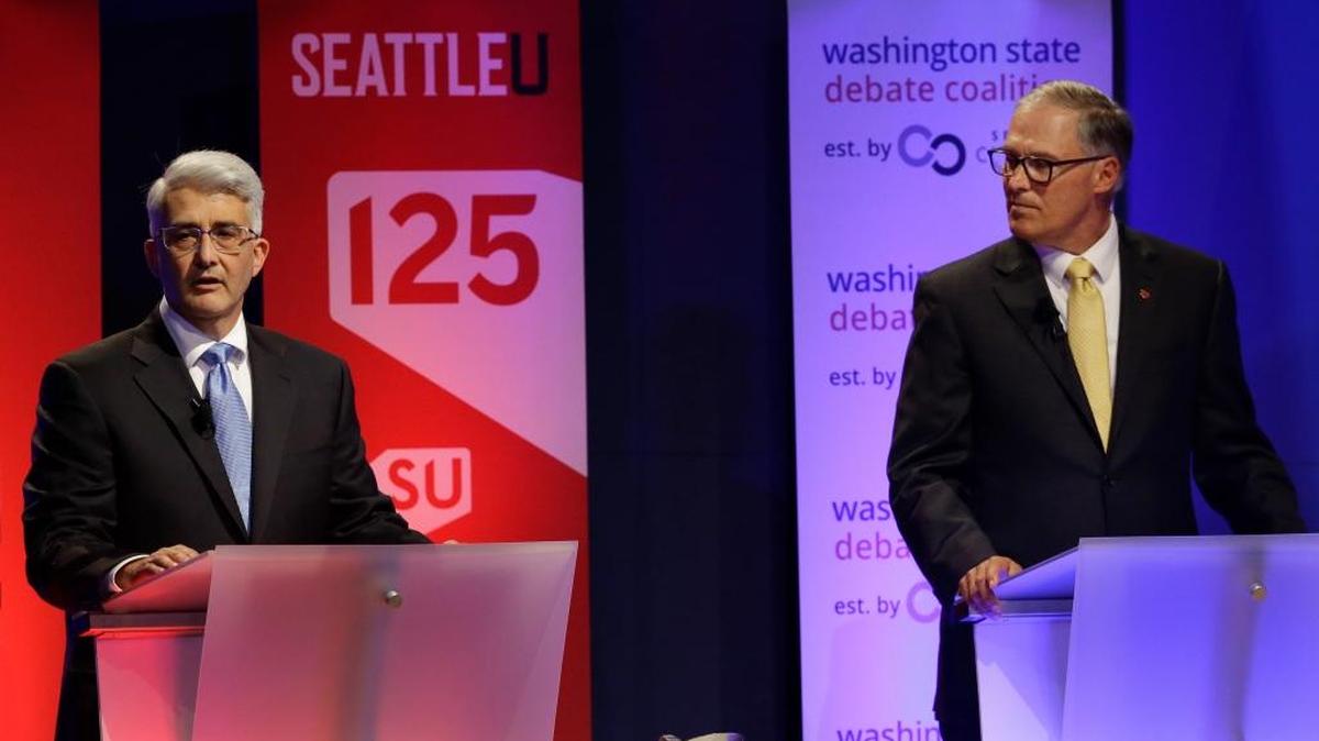 Washington Gov. Jay Inslee, right, a Democrat, and his Republican challenger, Bill Bryant, left, take part in a debate Sept. 26, 2016, in Seattle.