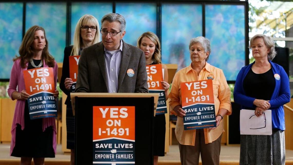 Daniel Weiner, center, Senior Rabbi at Temple De Hirsch Sinai in Bellevue, Wash., speaks at news conference on Sept. 21, 2016 in Bellevue promoting Initiative 1491, which will be on the ballot in the November elections. If passed by voters, the initiative would allow law enforcement or others to obtain court orders to temporarily take guns from people considered a danger to themselves or others. Weiner is a founding member of the Washington Alliance for Gun Responsibility.