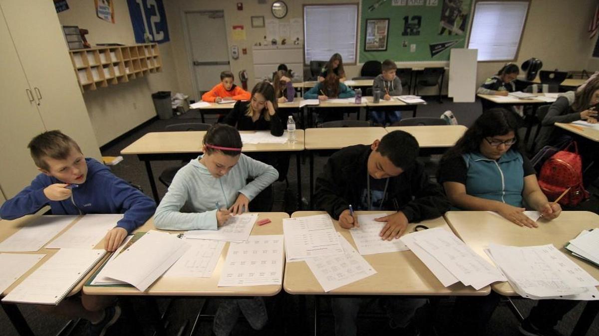 Sixth-grade students at Ballou Junior High in Puyallup work on classroom assignments during math studies in this photo from October 2015. Washington is now finishing its plan to comply with a new federal education law, the Every Student Succeeds Act, which replaced the widely criticized school accountability law No Child Left Behind.