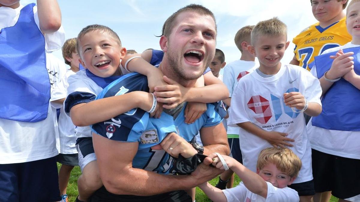 Football campers swarm and take down Jake Locker, then a Tennessee Titans quarterback, at Locker’s annual youth football camp at Ferndale High on June 29, 2013. Locker, a Ferndale native, asked the city council to prevent a second marijuana store from opening, citing concerns about keeping the drug from kids and focusing on families.