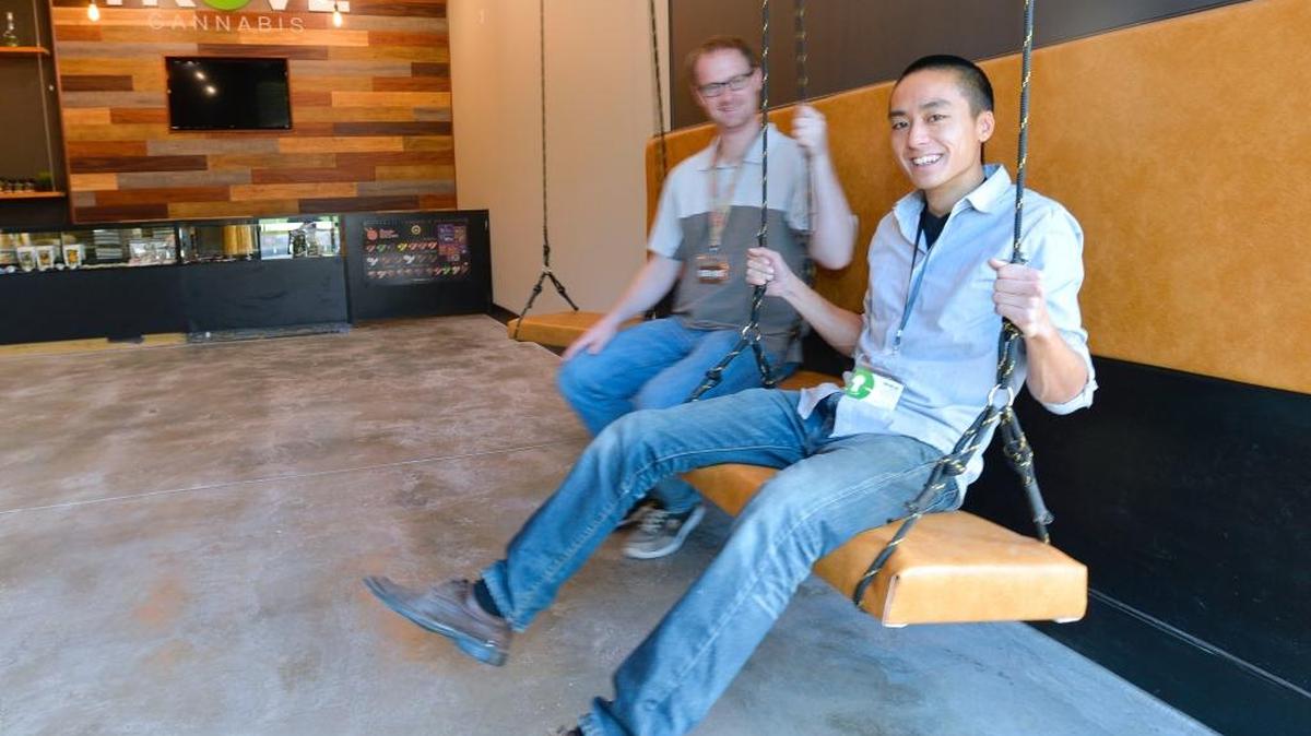 Co-owners and Western Washington University alumni Stephen Reed and Yin-Ho Lai sit on swings in their new recreational pot store, Trove Cannabis, on Samish Way on Monday, Nov. 9, 2015. The store opens Friday, Nov. 13.