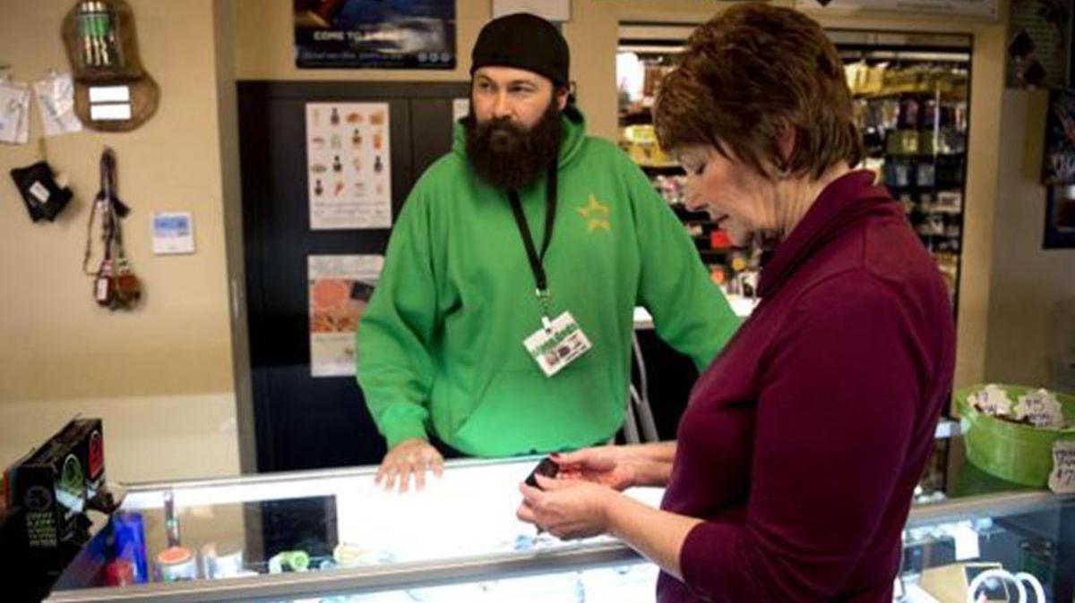 Cathy Smith, right, one of the owners of Sativa Sisters Recreational Marijuana Store in Spokane Valley, Wash., checks out a popular vaporizer with salesman Eric Garcia on Jan. 8, 2016.