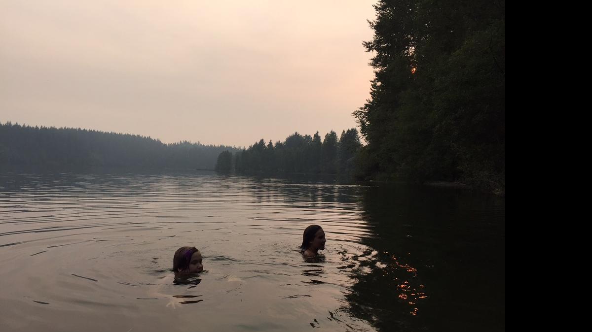 
Smoke from large fires in British Columbia and smaller fires in Whatcom County color the sky on Sunday evening, July 5, over Lake Padden in Bellingham. The unusually warm spring and summer created high-risk wildfire conditions. The weather trend also made for good outdoor swimming; people at Lake Padden over the Fourth of July weekend reported “bathwater” conditions.
